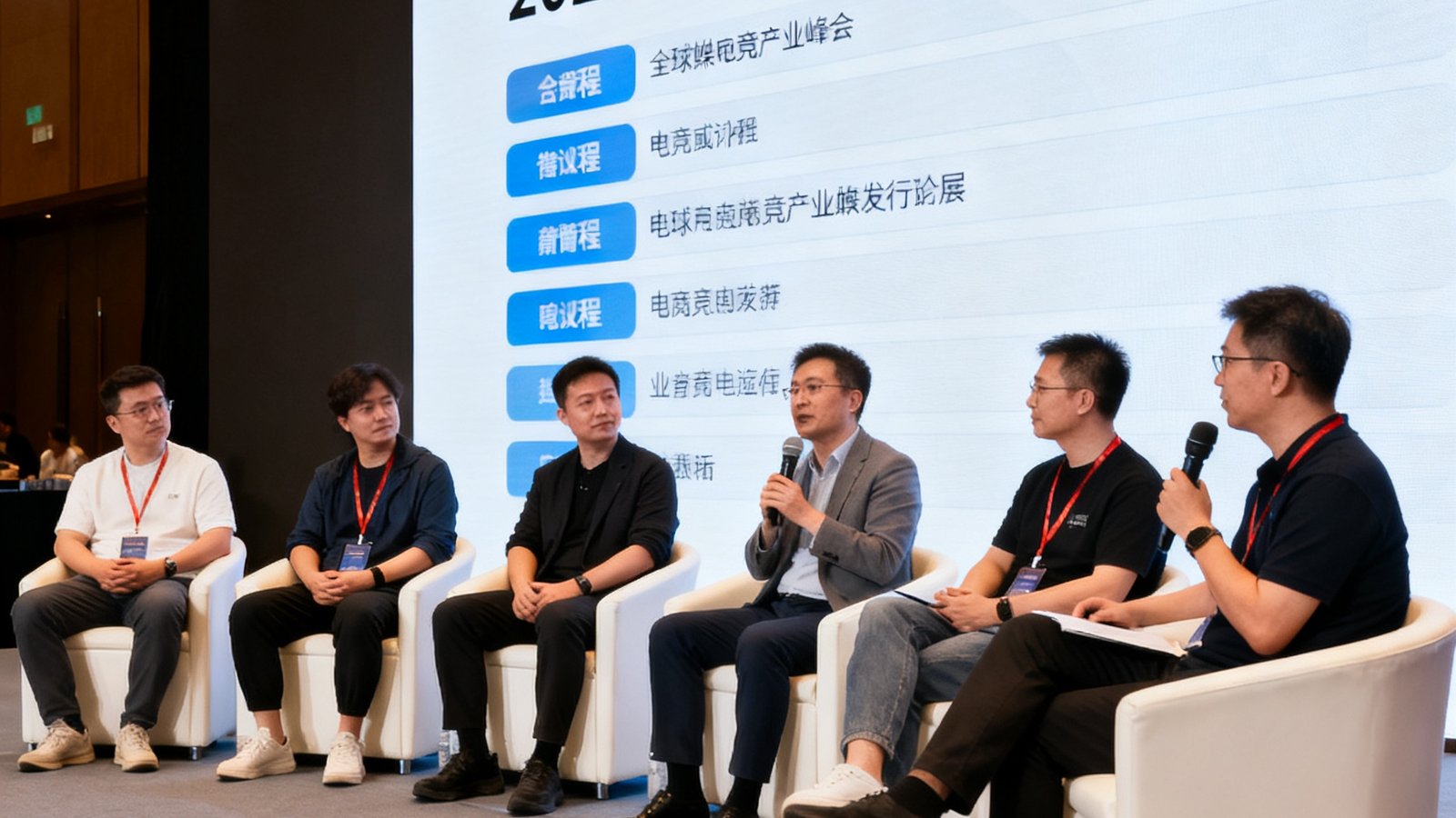 2025全球电竞产业峰会现场，多位行业领袖在圆桌论坛上讨论电竞媒体发展趋势，背景大屏幕显示议程